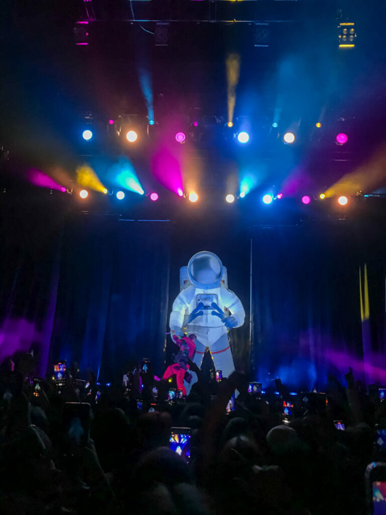 L'artiste DPR LIVE performe devant un astronaute gonflable.